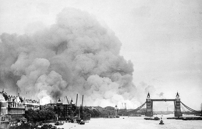 Pohled na Tower a řeku Temži po bombardování během Blitz, 7. září 1940. Dým stoupá z poničených částí Londýna po německém leteckém útoku.