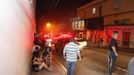 A police officer helps a woman next to Kiss nightclub in the southern city of Santa Maria, 187 miles (301 km) west of the state capital of Porto Alegre, in this picture taken by Agencia RBS, January 27, 2013. At least 200 people were killed in the nightclub fire in southern Brazil on Sunday after a band's pyrotechnics show set the building ablaze, and fleeing patrons were unable to find the emergency exits, local officials said. Bodies were still being removed from the Kiss nightclub in the southern city of Santa Maria, Major Gerson da Rosa Ferreira, who was leading rescue efforts at the scene for the military police, told Reuters. Local officials said 180 people were confirmed dead, and Ferreira said the death toll would rise above 200. He said the victims died of asphyxiation, or from being trampled, and that there were possibly as many as 500 people inside the club when the fire broke out at about 2:30 a.m. REUTERS/Germano Roratto/Agencia RBS (BRAZIL - Tags: DISASTER TPX IMAGES OF THE DAY) ATTENTION EDITORS - THIS IMAGE WAS PROVIDED BY A THIRD PARTY. NO SALES. NO ARCHIVES. FOR EDITORIAL USE ONLY. NOT FOR SALE FOR MARKETING OR ADVERTISING CAMPAIGNS. THIS PICTURE IS DISTRIBUTED EXACTLY AS RECEIVED BY REUTERS, AS A SERVICE TO CLIENTS. BRAZIL OUT. NO COMMERCIAL OR EDITORIAL SALES IN BRAZIL Published: Led. 27, 2013, 1:30 odp.