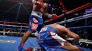 Chris Algieri of the U.S. falls as he takes a punch from Manny Pacquiao (L) of the Philippines during their World Boxing Organisation (WBO) 12-round welterweight title fi