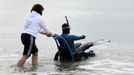 File photo dated 16/09/10 of French limbless swimmer Philippe Croizon is helped into the sea by team member Valerie Carbonnel during a training session in Folkestone, Kent. Philippe Croizon today became the first limbless person to swim the Channel.