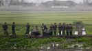 RNPS IMAGES OF THE YEAR 2012 - A music group performs on a path amid fields to greet the farmers at Hwanggumpyong Island, near the North Korean town of Sinuiju and the Chinese border city of Dandong June 6, 2012. REUTERS/Jacky Chen (NORTH KOREA - Tags: SOCIETY) Published: Pro. 4, 2012, 1:20 dop.