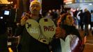 Supporters show their solidarity with Paris as they leave the stadium after the match was called off by police due to security reasons. REUTERS/Morris Mac Matzen