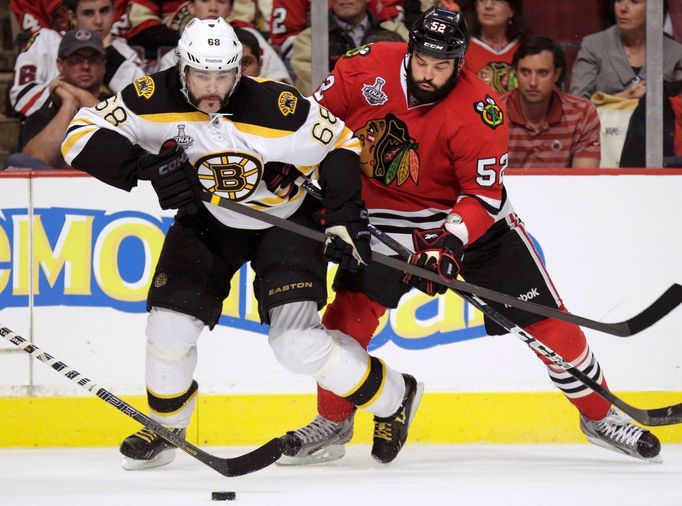 Boston Bruins right wing Jaromir Jagr (68) is checked by Chicago Blackhawks left wing Brandon Bollig (52) in double-overtime during Game 1 of their NHL Stanley Cup Finals