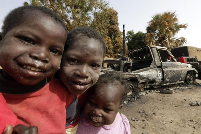 Young boys stand near vehicles, believed to belong to Islamist rebels and destroyed during French air strikes, in the recently liberated town of Diabaly January 24, 2013. REUTERS/Eric Gaillard (MALI - Tags: CIVIL UNREST CONFLICT MILITARY POLITICS) Published: Led. 24, 2013, 6:30 odp.