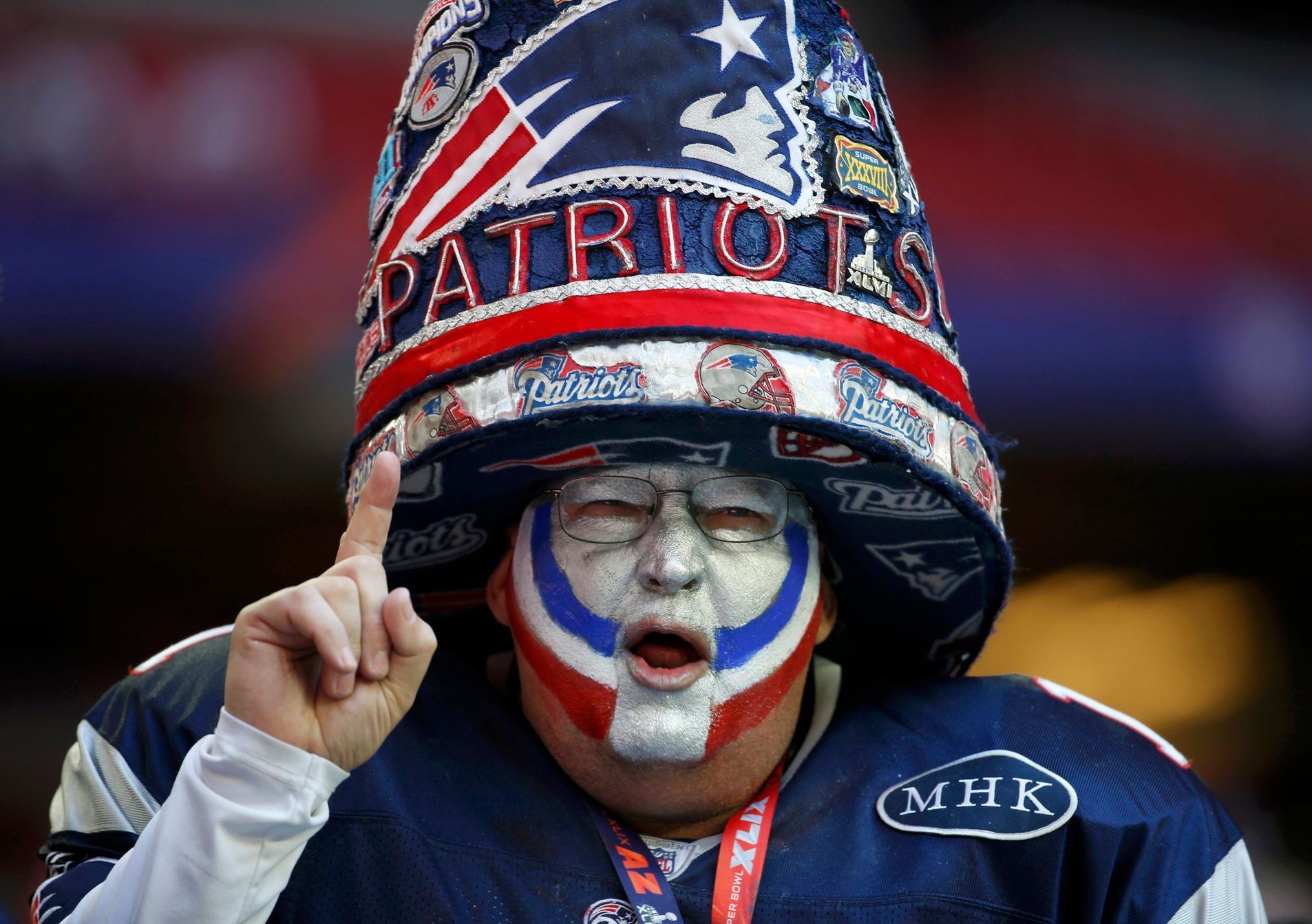 A New England Patriots fan celebrates while awaiting the start of the NFL Super Bowl XLIX football game against the Seattle Seahawks in Glendale