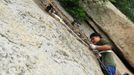 HUAYIN, CHINA - AUGUST 13: (CHINA OUT) Legless man Chen Zhou climbs the Huashan Mountain on August 13, 2012 in Huayin, Shaanxi Province of China. Legless 29-year-old man Chen Zhou from Cangshan of Shandong Province spent two days, 19 hours in total, climbing by arms to the top of Huashan Mountain. Chen lost his legs after falling off a train at the age of 13, but he has since strived to be stronger and joined in many public performances to encourage other people. Chen Zhou will climb the Taishan Mountain in Shandong province in the following months. ( automatický překlad do češtiny )