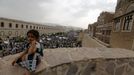 A girl sits on a wall as Houthi followers demonstrate against Saudi-led air strikes in Yemen's capital Sanaa July 24, 2015.