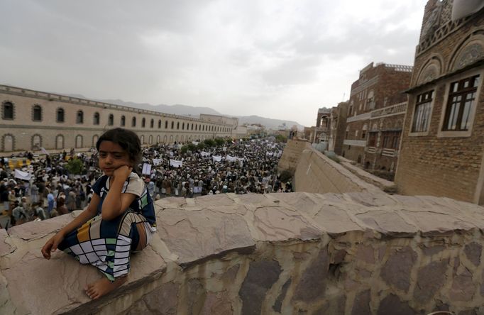 A girl sits on a wall as Houthi followers demonstrate against Saudi-led air strikes in Yemen's capital Sanaa July 24, 2015.