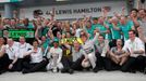 The Mercedes Formula One team celebrate outside their garage Lewis Hamilton of Britain (5th L) and Nico Rosberg of Germany (4th R) coming in first and second respectively