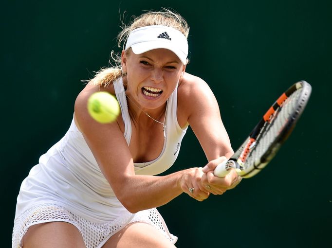 Caroline Wozniacká of Denmark hits a shot during her match against Denisa Allertova of the Czech Republic at the Wimbledon Tennis Championships in London