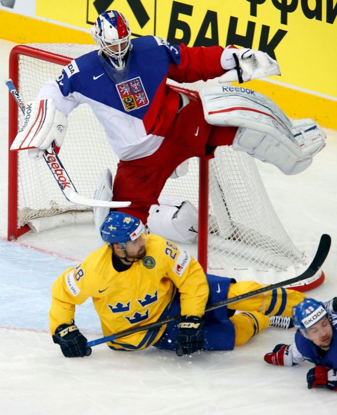 Goalie Alexander Salak of the Czech Republic (top) avoids a collision with Sweden's Dick Axelsson (bottom) during the first period of their men's ice hockey World Champio