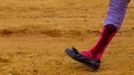 Spanish matador Nazare walks with his injured calf after being gored by a bull during a bullfight in Seville