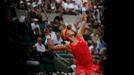 Eugenie Bouchard of Canada serves to Carla Suarez Navarro of Spain during their women's quarter-final match at the French Open Tennis tournament at the Roland Garros stad