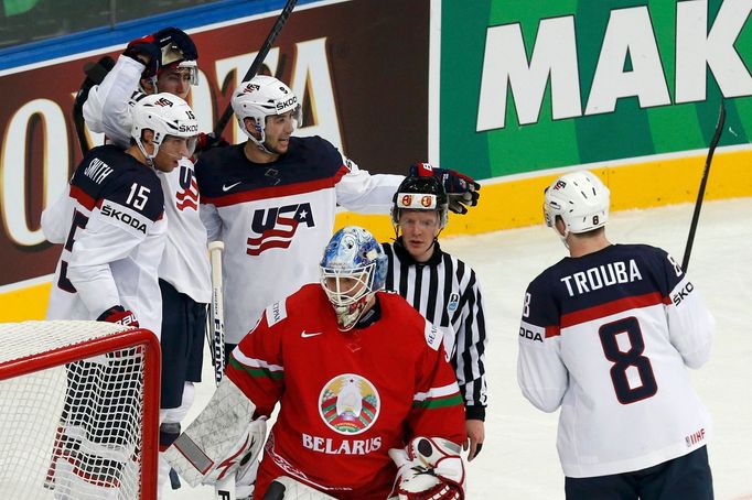 Brock Nelson of the U.S. (top) celebrates his goal with team mates Craig Smith (15), Jacob Trouba (8) and Tyler Johnson (9) as goalkeeper Andrei Mezin of Belarus looks on