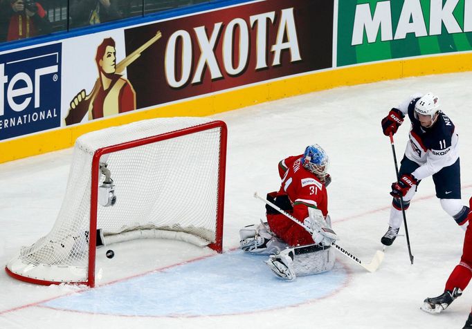 Brock Nelson of the U.S. scores past by goalkeeper Andrei Mezin of Belarus during the first period of their men's ice hockey World Championship Group B game at Minsk Aren