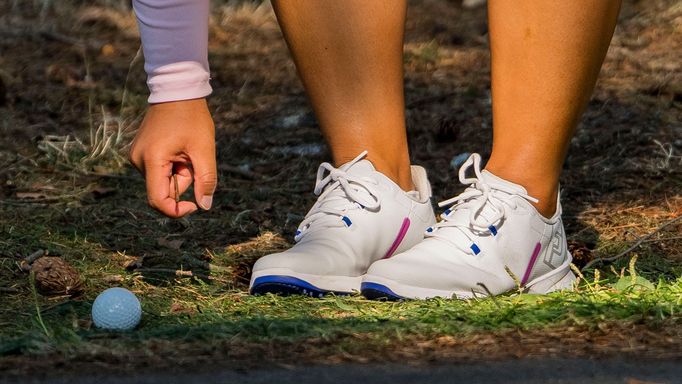 Aug 27, 2023; Vancouver, British Columbia, CAN; Megan Khang picks sticks away from her ball after her tee shot ended up next to the cart path on the sixth hole during the