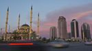 Cars drive along Akhmad Kadyrov Avenue, with the Heart of Chechnya mosque and skyscrapers in the background in the Chechen capital Grozny April 27, 2013. The naming of two Chechens, Dzhokhar and Tamerlan Tsarnaev, as suspects in the Boston Marathon bombings has put Chechnya - the former site of a bloody separatist insurgency - back on the world's front pages. Chechnya appears almost miraculously reborn. The streets have been rebuilt. Walls riddled with bullet holes are long gone. New high rise buildings soar into the sky. Spotless playgrounds are packed with children. A giant marble mosque glimmers in the night.Yet, scratch the surface and the miracle is less impressive than it seems. Behind closed doors, people speak of a warped and oppressive place, run by a Kremlin-imposed leader through fear. Picture taken April 27, 2013. REUTERS/Maxim Shemetov (RUSSIA - Tags: SOCIETY POLITICS RELIGION TRANSPORT) ATTENTION EDITORS: PICTURE 03 OF 40 FOR PACKAGE 'INSIDE MODERN CHECHNYA'. SEARCH 'REBUILDING CHECHNYA' FOR ALL IMAGES Published: Kvě. 1, 2013, 7:16 dop.