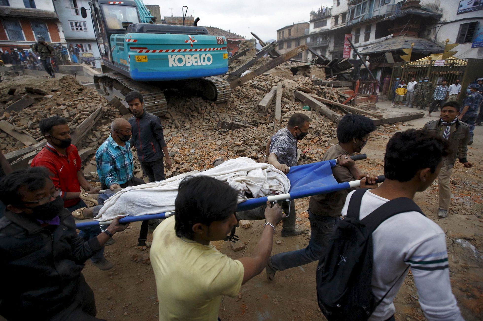 Rescue workers carry the body of a victim on a stretcher, after a 7.9 magnitude earthquake hit, in Kathmandu, Nepal