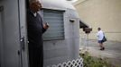 Bill Niederberger, 81, watches the mailman from his trailer in which he has lived for over 30 years, in Village Trailer Park in Santa Monica, California, July 12, 2012. Developer Marc Luzzatto wants to relocate residents from the trailer park to make way for nearly 500 residences, office space, stores, cafes and yoga studios, close to where a light rail line is being built to connect downtown Los Angeles to the ocean. Village Trailer Park was built in 1951, and 90 percent of its residents are elderly, disabled or both, according to the Legal Aid Society. Many have lived there for decades in old trailers which they bought. The property is valued at as much as $30 million, according the LA Times. Picture taken July 12, 2012. REUTERS/Lucy Nicholson (UNITED STATES - Tags: SOCIETY REAL ESTATE BUSINESS POLITICS) Published: Čec. 14, 2012, 7:20 dop.