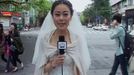 Journalist Chen Ying reports dressed in her wedding gown after an earthquake hit Ya'an, Sichuan province in this still image taken from footage shot April 20, 2013. Chen was having make-up applied before her wedding ceremony when the earthquake struck, and carried on with the ceremony after a quick report on the street, local media reported. Footage taken on April 20, 2013. REUTERS/Ya'an TV via Reuters TV (CHINA - Tags: DISASTER SOCIETY MEDIA) ATTENTION EDITORS - THIS IMAGE WAS PROVIDED BY A THIRD PARTY. IT WAS PROCESSED BY REUTERS TO ENHANCE QUALITY. AN UNPROCESSED VERSION WILL BE PROVIDED SEPARATELY. NO SALES. NO ARCHIVES. FOR EDITORIAL USE ONLY. NOT FOR SALE FOR MARKETING OR ADVERTISING CAMPAIGNS. CHINA OUT. NO COMMERCIAL OR EDITORIAL SALES IN CHINA Published: Dub. 21, 2013, 11:03 dop.