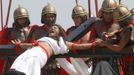 Ruben Enaje, 52, who is portraying Jesus Christ for the 27th time, screams while a man who plays a Roman soldier hammers a nail into his palm during a Good Friday crucifixion re-enactment in San Pedro Cutud town, Pampanga province, north of Manila March 29, 2013. The Roman Catholic church frowns upon the gory spectacle held in the Philippine village of Cutud every Good Friday but does nothing to deter the faithful from emulating the suffering of Christ and taking a painful route to penitence. Holy Week is celebrated in many Christian traditions during the week before Easter. REUTERS/Romeo Ranoco (PHILIPPINES - Tags: RELIGION SOCIETY TPX IMAGES OF THE DAY) Published: Bře. 29, 2013, 7:24 dop.