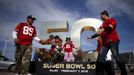 A family poses on a Super Bowl logo outside Levi's Stadium before NFL Super Bowl 50 in Santa Clara