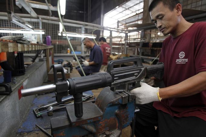 A former illegal gunsmith inspects a newly assembled multi-action shotgun at Shooters Arms, a gun manufacturing company exporting different kinds of weapons to other countries, in Cebu city in central Philippines July 7, 2012. In the Philippines, they vote with their trigger fingers. Elections mean big business for illegal gunsmiths, who are looking forward to 2013 mid-term polls. With election-related violence commonplace, the Philippines imposes a ban on the carrying of guns for six months, from campaigning to the proclamation of winners. Picture taken July 7, 2012. To match Feature PHILIPPINES-GUNS/ REUTERS/Erik De Castro (PHILIPPINES - Tags: SOCIETY POLITICS BUSINESS CRIME LAW) Published: Čec. 29, 2012, 1:55 dop.