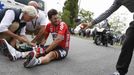 Lotto-Belisol team rider Gregory Henderson of New Zealand gets assistance after crashing during the 163.5 km fourth stage of the Tour de France cycling race from Le Touqu