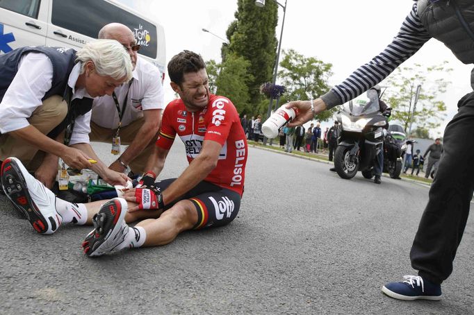 Lotto-Belisol team rider Gregory Henderson of New Zealand gets assistance after crashing during the 163.5 km fourth stage of the Tour de France cycling race from Le Touqu