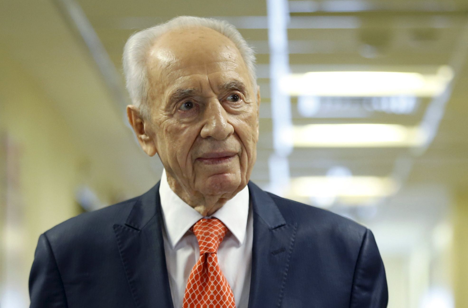 Former Israeli President Peres delivers a statement to the media as he is discharged from a hospital near Tel Aviv