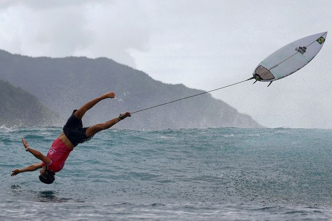 Paris 2024 Olympics - Surfing - Men's Round 3 - Heat 6 - Teahupo'o, Tahiti, French Polynesia  - July 29, 2024. Joao Chianca of Brazil jumps in celebration after riding a