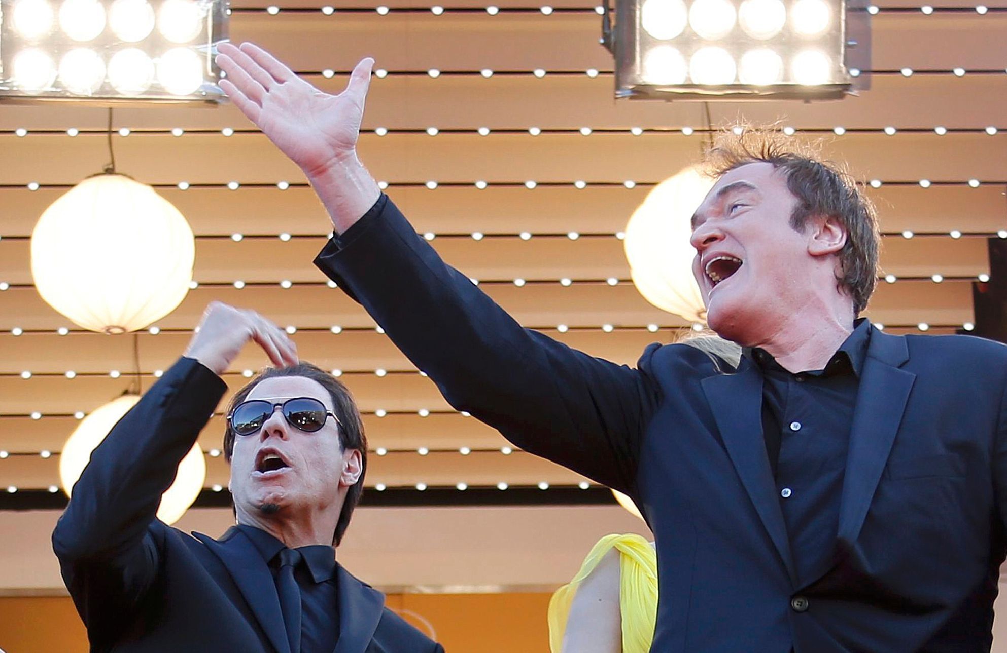 Director Quentin Tarantino and actor John Travolta pose on the red carpet they arrive for the screening of the film &quot;Sils Maria&quot; in competition at the 67th Cannes Film Festival in Cannes