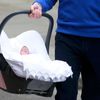 Britain's Prince William carries his baby daughter in a car seat outside the Lindo Wing of St Mary's Hospital, in London