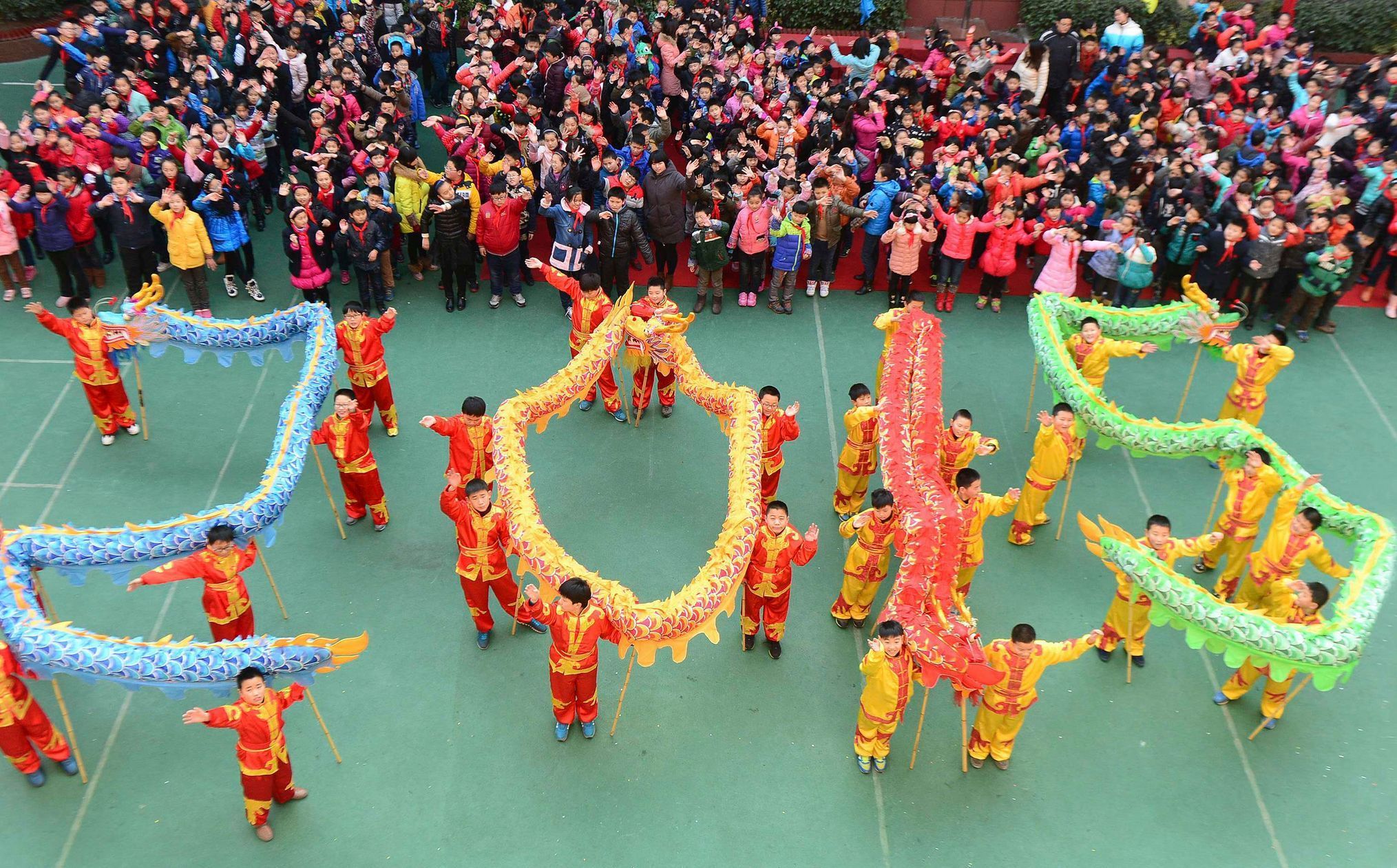 Students with dragon dance props form &quot;2015&quot; to welcome the upcoming New Year at an art school in Hefei