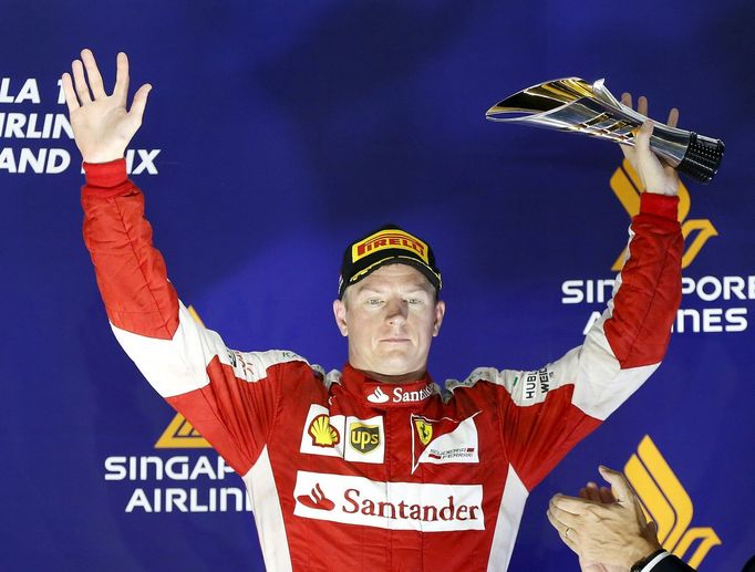 Ferrari Formula One driver Kimi Raikkonen of Finland celebrates on the podium after he placed third in the Singapore F1 Grand Prix at the Marina Bay street circuit Septem