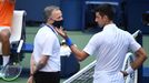 Sep 6, 2020; Flushing Meadows, New York, USA; Novak Djokovic of Serbia discusses with a tournament official after being defaulted for striking a lines person with a ball