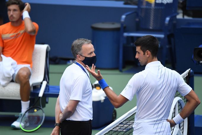 Sep 6, 2020; Flushing Meadows, New York, USA; Novak Djokovic of Serbia discusses with a tournament official after being defaulted for striking a lines person with a ball