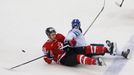 Canada's Mark Scheifele (L) and Finland's Iiro Pakarinen fall on ice during the first period of their men's ice hockey World Championship quarter-final game at Chizhovka