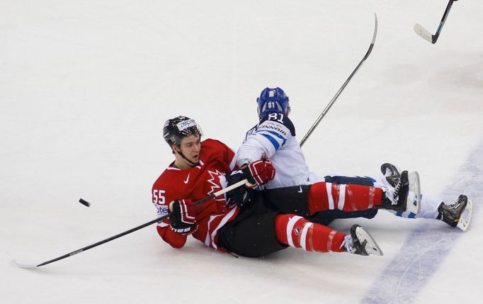 Canada's Mark Scheifele (L) and Finland's Iiro Pakarinen fall on ice during the first period of their men's ice hockey World Championship quarter-final game at Chizhovka