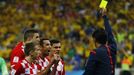 Referee Yuichi Nishimura (R) of Japan shows the yellow card to Croatia's Dejan Lovren (2nd R), for a foul on Brazil's Fred (unseen), during the 2014 World Cup opening mat