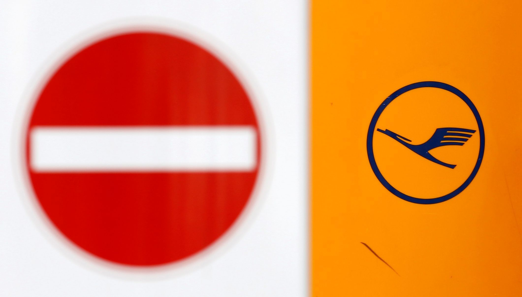 Traffic sign is seen next to logo of Lufthansa at Munich's airport
