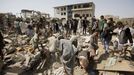 Vendors and people salvage goods from under the rubble of shops destroyed by a Saudi-led air strike that hit a marketplace in Yemen's capital Sanaa July 20, 2015.