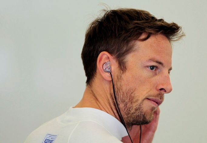 McLaren Formula One driver Jenson Button of Britain looks on during the first practice session of the Bahrain F1 Grand Prix at the Bahrain International Circuit (BIC) in