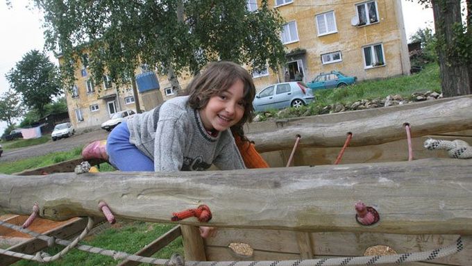 Děvčátko si hraje před romským "panelákem" na okraji Dobré Vody