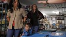 Mercedes Santos (L) and Theresa Volpe listen to directions at a food pantry where they were volunteering with their son Jaidon Santos-Volpe in Evanston, Illinois, December 28, 2012. Santos and Volpe are a same-sex couple raising two of their biological children as they struggle to get same-sex marriages passed into law in Illinois. Picture taken December 28, 2012. REUTERS/Jim Young (UNITED STATES - Tags: SOCIETY) Published: Bře. 25, 2013, 6:08 odp.