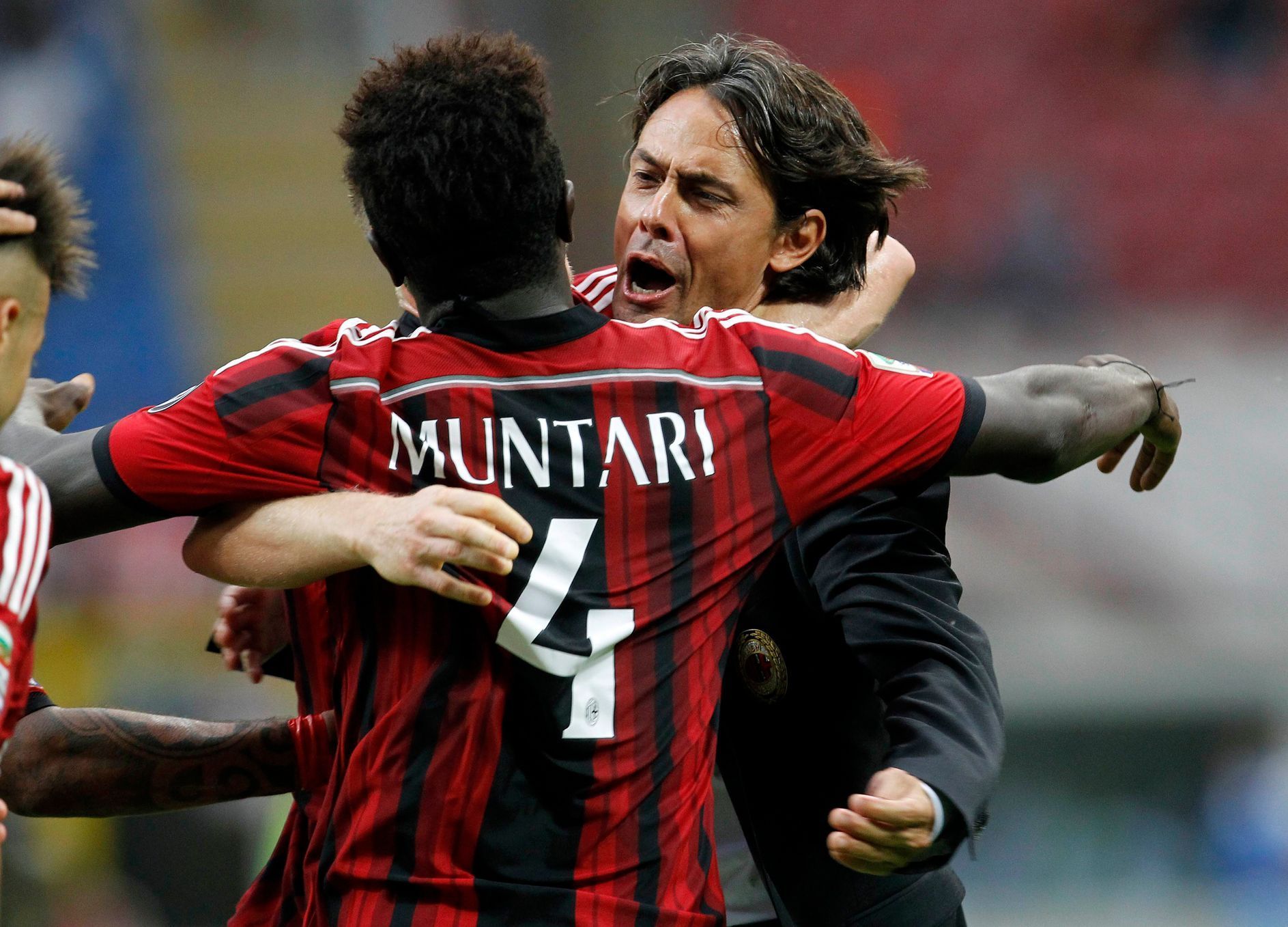AC Milan's Muntari celebrates with his coach Inzaghi after scoring goal against Lazio  during their Italian Serie A match in Milan