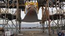 Space center workers watch as the space shuttle Discovery is elevated in the Mate Demate facility at Kennedy Space Center in Cape Canaveral