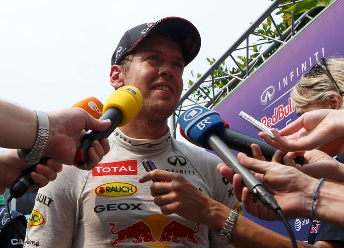 Red Bull Formula One driver Sebastian Vettel of Germany talks to the media after the second practice session of the Malaysian F1 Grand Prix at Sepang International Circui