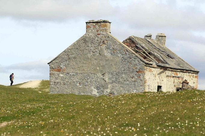 Artist and poet Barry Edgar Pilcher, age 69, poses for a photograph as he plays the saxaphone on the Island of Inishfree in County Donegal May 1, 2012. Pilcher is the only inhabitant of the island on which he has lived for the past 20 years. He only leaves the island once a week to collect his pension and buy groceries on the mainland. REUTERS/Cathal McNaughton (IRELAND - Tags: ENTERTAINMENT SOCIETY) Published: Kvě. 2, 2012, 11:20 dop.