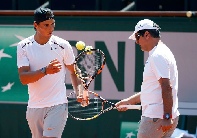 Rafael Nadal of Spain and his coach Toni Nadal attend a training session for the French Open tennis tournament at the Roland Garros stadium in Paris